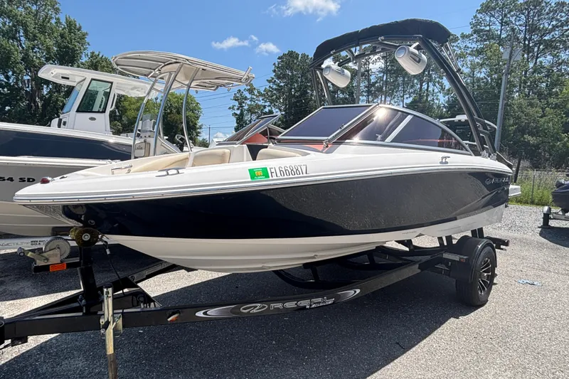 The Image of 2018 Regal 1900 ES Bowrider boat on trailer, parked outdoors. - 0