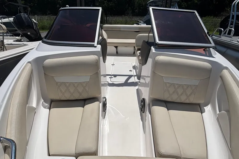 Slide: The Image of 2018 Regal 1900 ES Bowrider interior with beige seating and open windshield. - 10