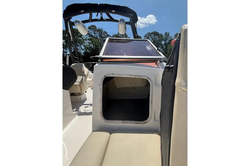 Slide: The Image of 2018 Regal 1900 ES Bowrider interior with open storage compartment and seating. - 11