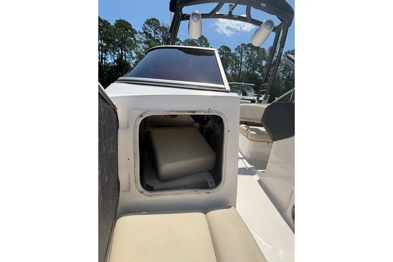 Slide: The Image of 2018 Regal 1900 ES Bowrider interior storage compartment with seating and canopy. - 12