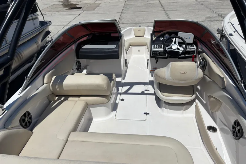 Slide: The Image of 2018 Regal 1900 ES Bowrider interior with beige seating and modern dashboard. - 14