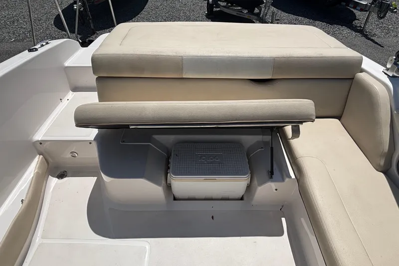 Slide: The Image of 2018 Regal 1900 ES Bowrider interior with beige seating and storage compartment. - 17