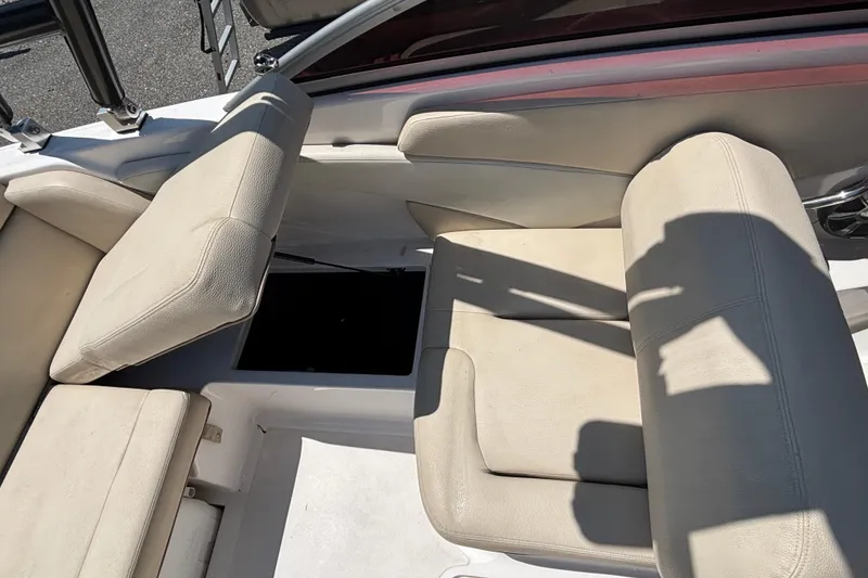 Slide: The Image of 2018 Regal 1900 ES Bowrider interior seating with storage compartment open. - 18