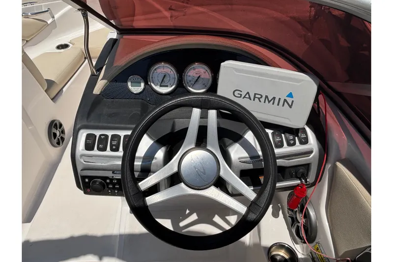Slide: The Image of 2018 Regal 1900 ES Bowrider dashboard with Garmin navigation system and steering wheel. - 22