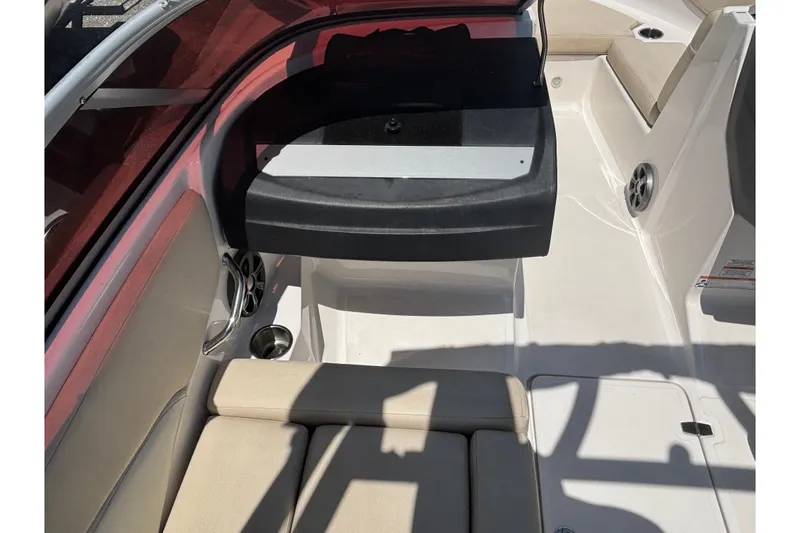 Slide: The Image of 2018 Regal 1900 ES Bowrider interior with beige seating and cup holders. - 23