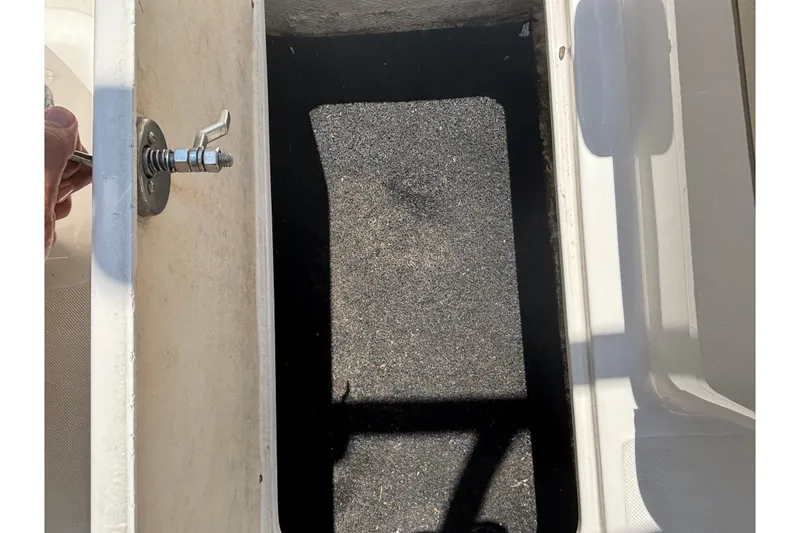 Slide: The Image of Open storage compartment in a 2018 Regal 1900 ES Bowrider boat. - 25