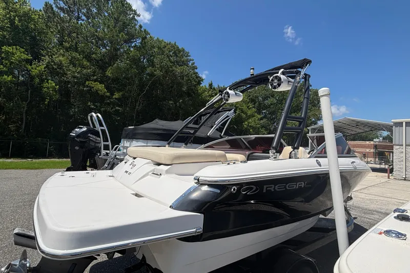 Slide: The Image of 2018 Regal 1900 ES Bowrider boat parked outdoors on a sunny day. - 4