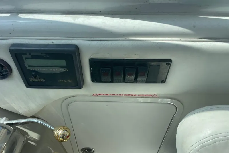 Slide: The Image of Control panel of a 2006 Sea Ray 40 Motor Yacht with system monitor and switches. - 15