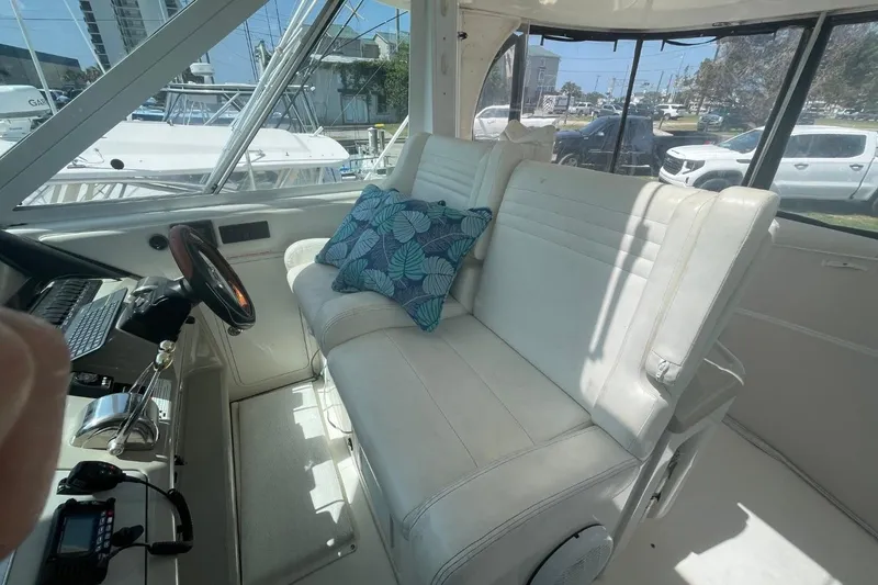 Slide: The Image of Interior of 2006 Sea Ray 40 Motor Yacht with white seating and blue cushions. - 16