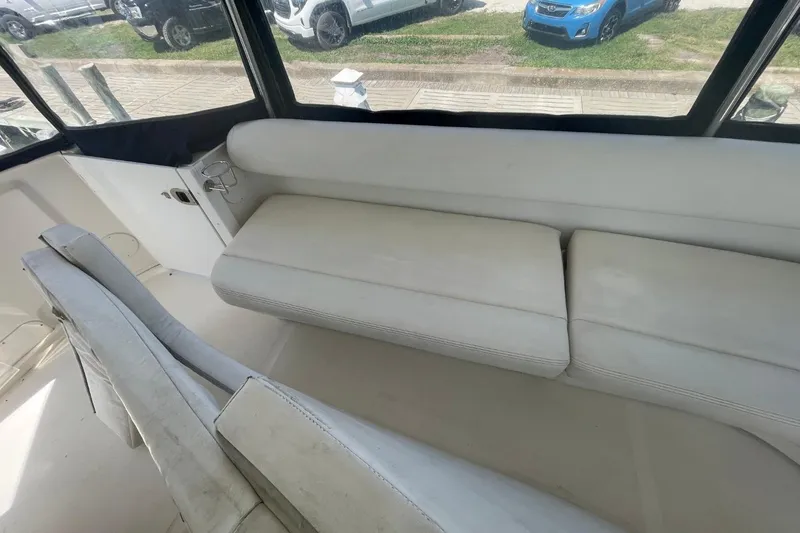 Slide: The Image of Interior seating of a 2006 Sea Ray 40 Motor Yacht, featuring white cushioned seats. - 18