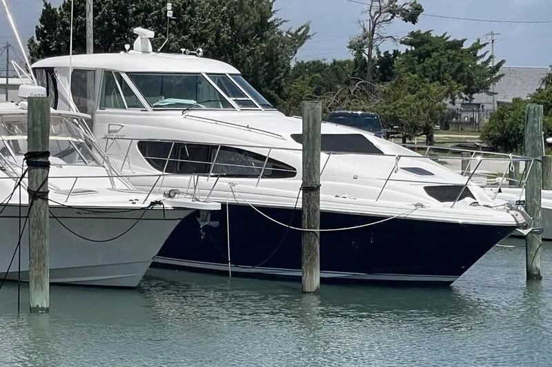 Slide: The Image of 2006 Sea Ray 40 Motor Yacht docked in a marina, surrounded by calm waters. - 2