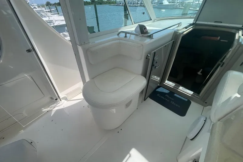 Slide: The Image of 2006 Sea Ray 40 Motor Yacht interior with white seating and open cabin door. - 20