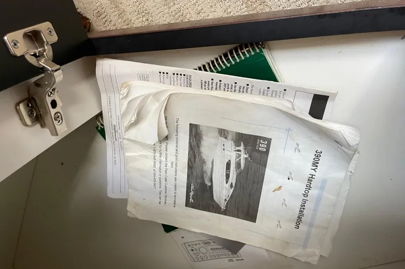 Slide: The Image of Manuals and documents for a 2006 Sea Ray 40 Motor Yacht, including a 390MY Hardtop Installation guide. - 25
