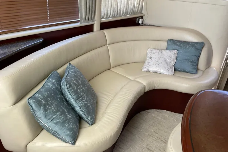 Slide: The Image of Luxurious interior of 2006 Sea Ray 40 Motor Yacht with curved leather seating and decorative pillows. - 26