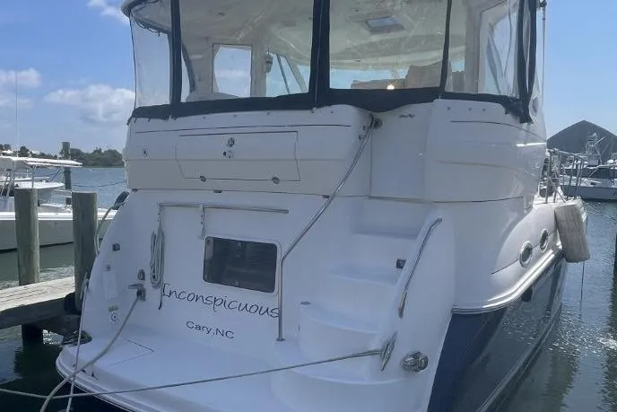 Slide: The Image of 2006 Sea Ray 40 Motor Yacht docked, rear view with steps and clear enclosure. - 3