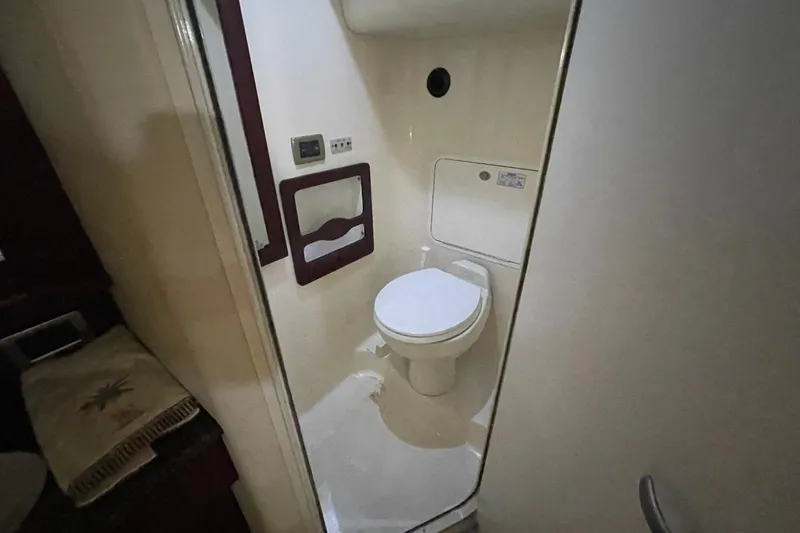 Slide: The Image of Bathroom interior of a 2006 Sea Ray 40 Motor Yacht, featuring a compact toilet. - 31