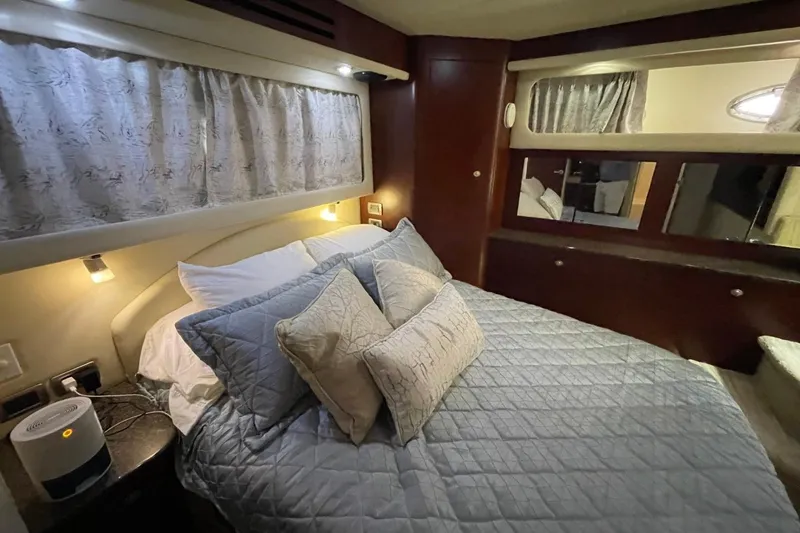 Slide: The Image of Luxurious bedroom interior of 2006 Sea Ray 40 Motor Yacht with elegant bedding and ambient lighting. - 32