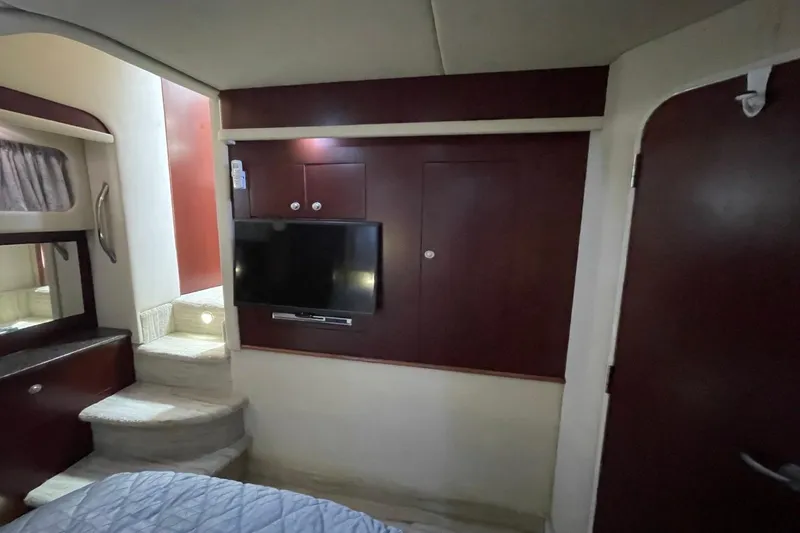Slide: The Image of Interior of 2006 Sea Ray 40 Motor Yacht with TV, stairs, and wood paneling. - 33
