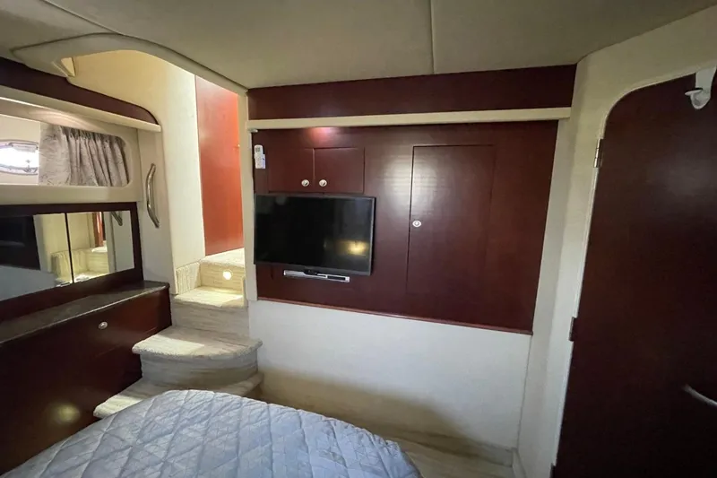 Slide: The Image of Interior of 2006 Sea Ray 40 Motor Yacht with TV, stairs, and wood paneling. - 34