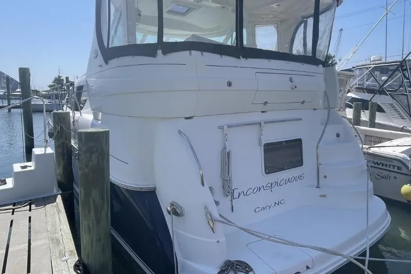 Slide: The Image of 2006 Sea Ray 40 Motor Yacht docked, rear view with "Inconspicuous" name visible. - 4