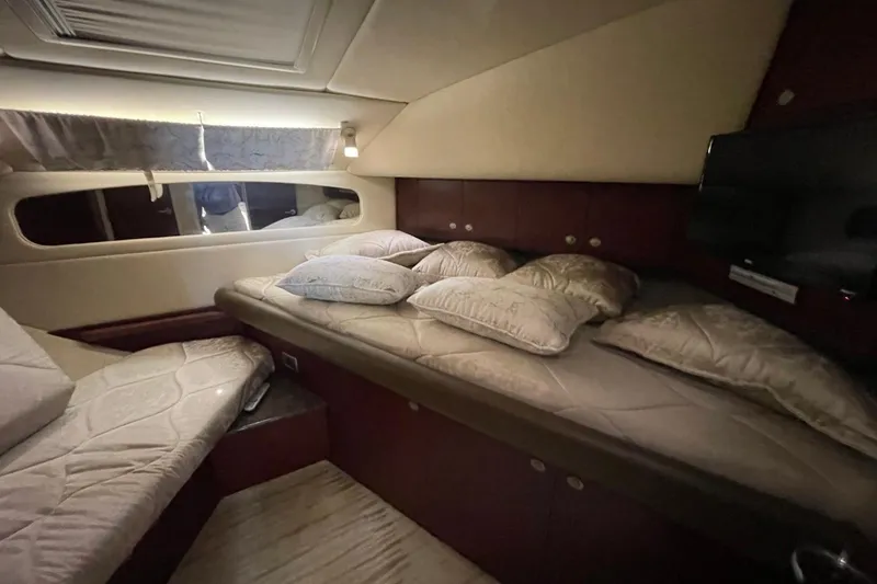 Slide: The Image of Luxurious cabin interior of a 2006 Sea Ray 40 Motor Yacht with cozy bedding. - 43