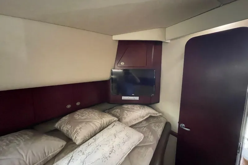 Slide: The Image of Cozy bedroom interior of 2006 Sea Ray 40 Motor Yacht with TV and plush pillows. - 47