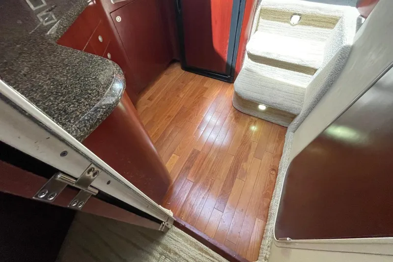 Slide: The Image of Interior of 2006 Sea Ray 40 Motor Yacht with wooden flooring and carpeted stairs. - 48