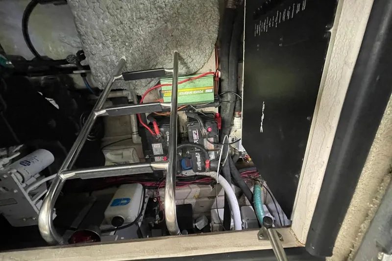 Slide: The Image of Engine compartment of a 2006 Sea Ray 40 Motor Yacht, featuring batteries and wiring. - 50