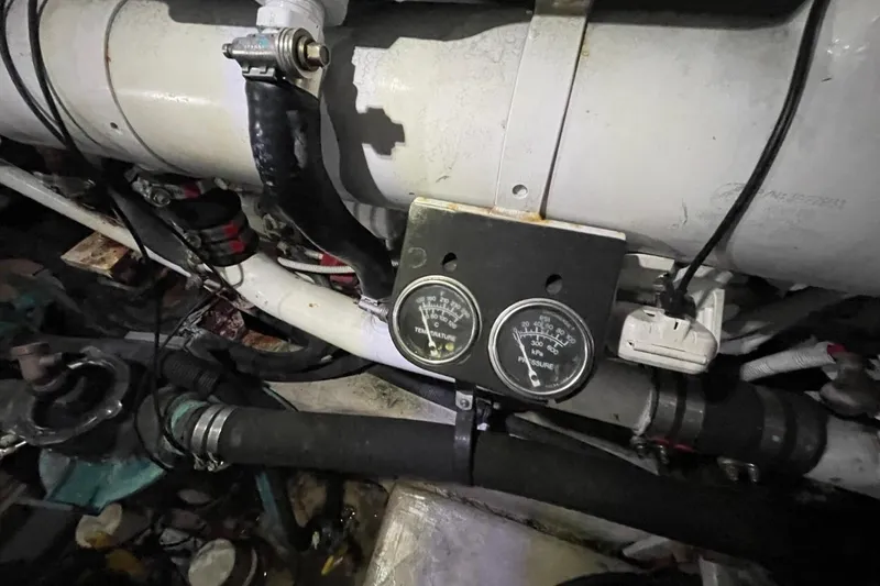 Slide: The Image of Engine room of 2006 Sea Ray 40 Motor Yacht with gauges and hoses visible. - 53