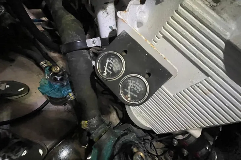 Slide: The Image of Engine compartment of a 2006 Sea Ray 40 Motor Yacht with gauges and hoses visible. - 54