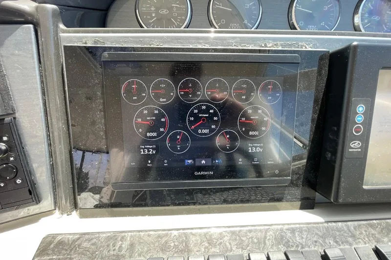 Slide: The Image of Dashboard of a 2006 Sea Ray 40 Motor Yacht with Garmin display showing gauges. - 63