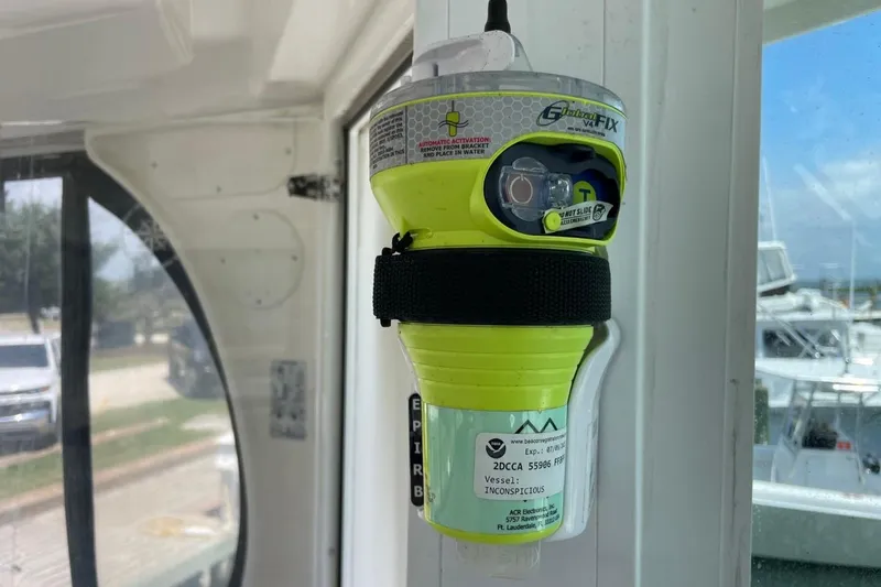 Slide: The Image of Emergency beacon on a 2006 Sea Ray 40 Motor Yacht, docked with boats visible outside. - 67