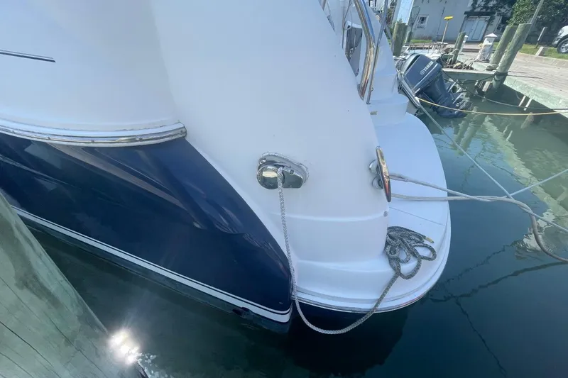 Slide: The Image of 2006 Sea Ray 40 Motor Yacht docked, showing stern and mooring ropes. - 9