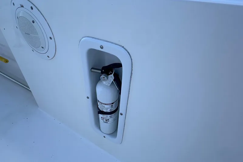 Slide: The Image of Fire extinguisher mounted on 2006 Edgewater 245CC boat, near speaker. - 15
