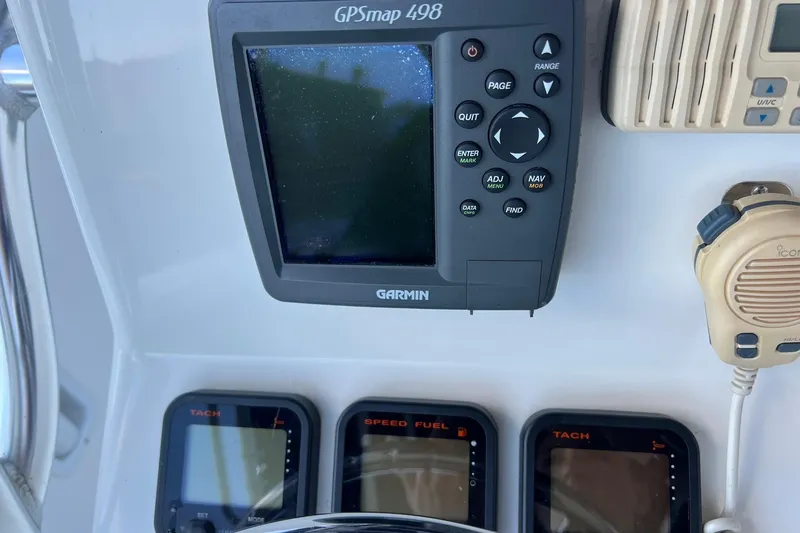 Slide: The Image of Garmin GPSmap 498 and gauges on 2006 Edgewater 245CC boat dashboard. - 25