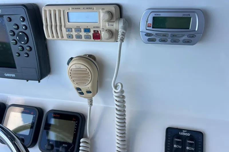 Slide: The Image of Control panel of a 2006 Edgewater 245CC boat with marine electronics and radio. - 26