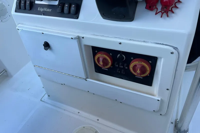 Slide: The Image of Control panel of a 2006 Edgewater 245CC boat with switches and dials. - 28