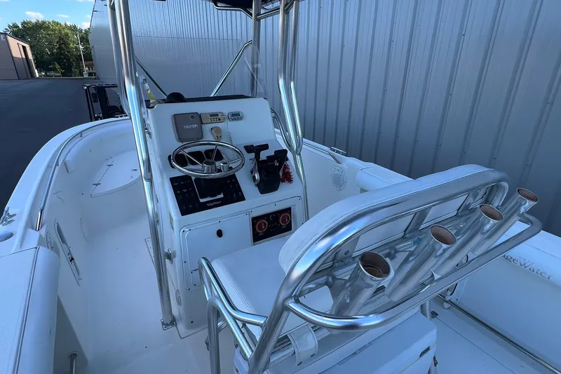 Slide: The Image of 2006 Edgewater 245CC boat interior with steering console and rod holders. - 29