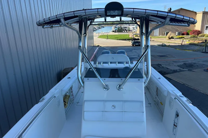Slide: The Image of 2006 Edgewater 245CC boat docked, featuring a sleek center console design. - 34
