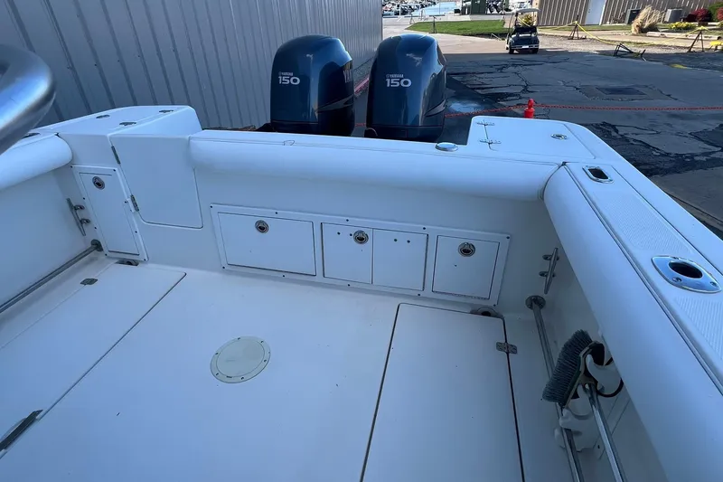 Slide: The Image of 2006 Edgewater 245CC boat deck with twin Yamaha 150 engines, dockside view. - 36