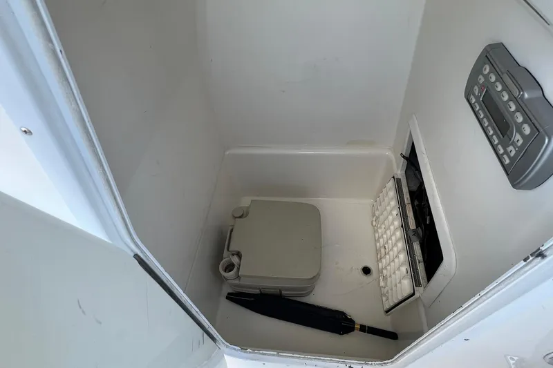 Slide: The Image of Interior of a 2006 Edgewater 245CC boat compartment with storage items. - 4