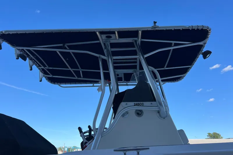 Slide: The Image of 2006 Edgewater 245CC boat with T-top against clear blue sky. - 41