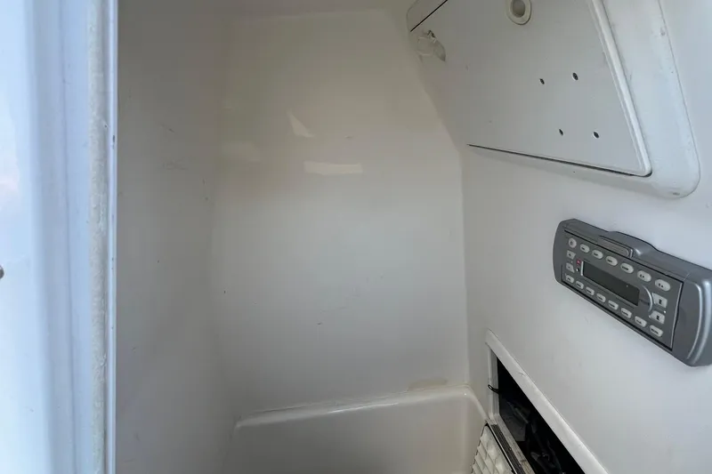 Slide: The Image of Interior of a 2006 Edgewater 245CC boat, featuring a control panel and storage compartment. - 5