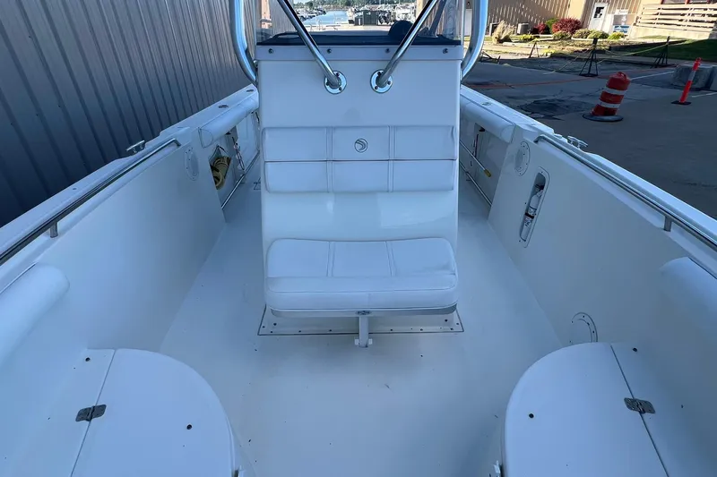 Slide: The Image of 2006 Edgewater 245CC boat interior with white seating and clean deck. - 9