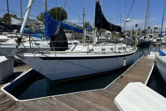 The Image of 1977 Ericson 35 sailboat docked at a marina, featuring classic design and sleek lines. - 0