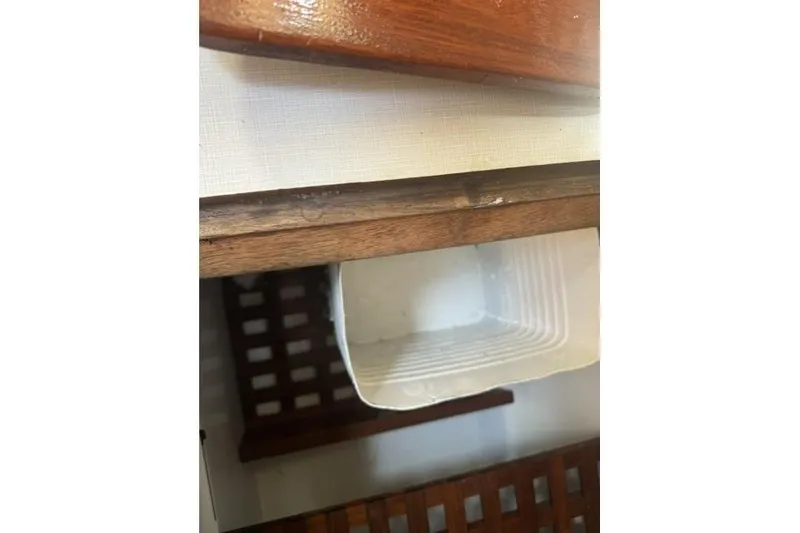 Slide: The Image of Interior of a 1977 Ericson 35 sailboat showing wooden cabinetry and storage area. - 20