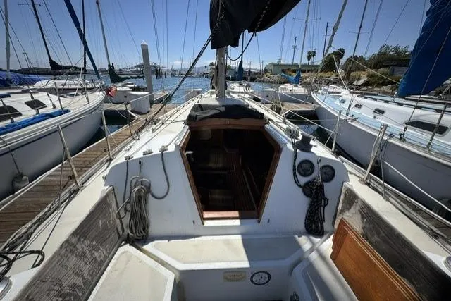 Slide: The Image of 1977 Ericson 35 sailboat docked at marina, view of cockpit and cabin entrance. - 3