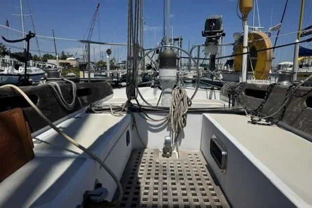 Slide: The Image of 1977 Ericson 35 sailboat cockpit with steering wheel, ropes, and marina background. - 4