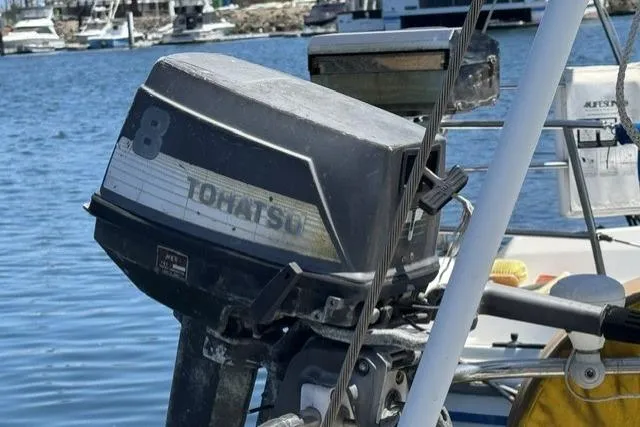 Slide: The Image of Outboard motor on a 1977 Ericson 35 sailboat, docked at a marina. - 8