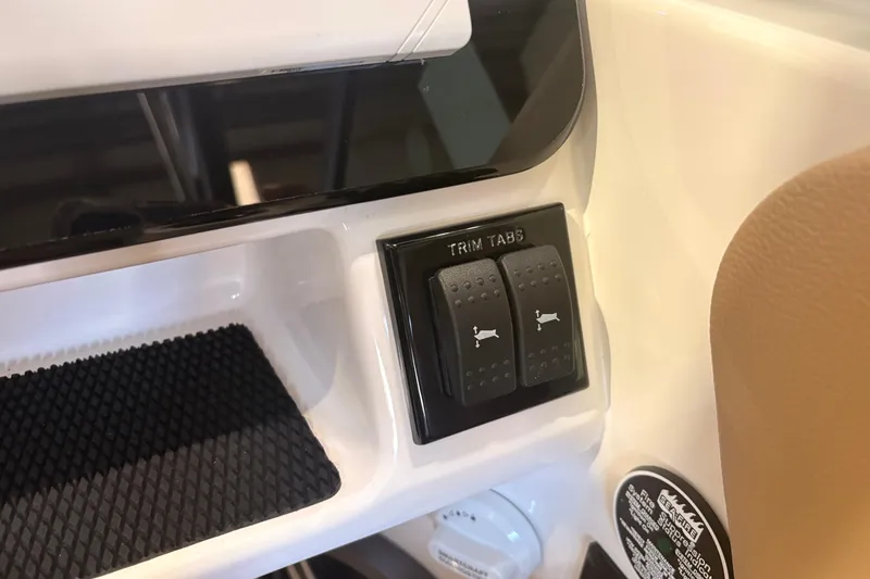 Slide: The Image of 2026 Sea Ray SDX 250 Surf trim tabs control panel close-up. - 11